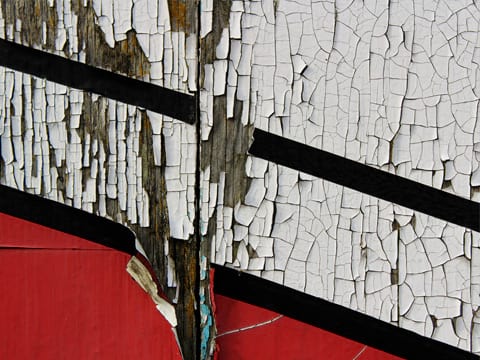 A wall with cracked and peeling paint indicates that it’s time for exterior painting.