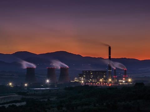 A power plant emitting VOCs into the air during production.