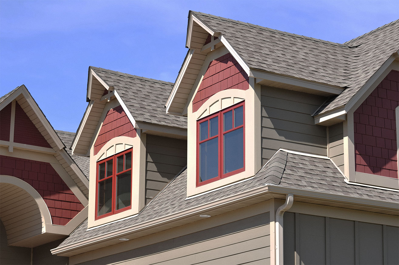 Bright red painted windows and salmon red details on gable dormers.