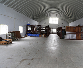 A factory painting project in Chicago. The large room is prepared for painting - all of the items are moved from one side to another.
