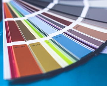 Paint color sample catalog on a blue table.
