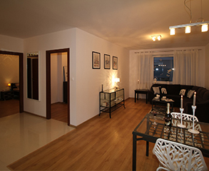 A cozy condo interior. Walls are painted a neutral white to enhance the brown furniture and decorations.