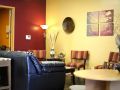 Living room with red and yellow painted walls and creative decor.