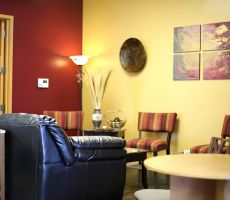 Living room with red and yellow painted walls and creative decor.