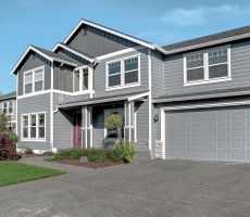 Large two story house with the exterior of the first floor painted a brighter shade of blue than the second.