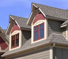 Bright red painted windows and salmon red details on gable dormers.